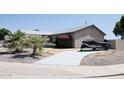 Attractive single-story home with desert landscaping and a covered boat or utility trailer in the driveway at 749 N 99Th St, Mesa, AZ 85207