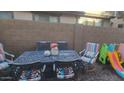 Backyard space with a patio dining set and a ' playset at 7521 S 31St Pl, Phoenix, AZ 85042
