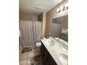Bathroom featuring a double vanity, toilet, and shower with tub at 7521 S 31St Pl, Phoenix, AZ 85042