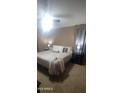 Primary bedroom with king bed, side tables, and neutral toned decor at 7521 S 31St Pl, Phoenix, AZ 85042