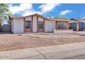 Inviting single-story home with brick details, showcasing a tidy and well-kept facade at 7614 W Cheery Lynn Rd, Phoenix, AZ 85033