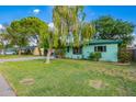 Charming home featuring a lush lawn, mature trees, and a quaint facade at 811 W Ocotillo Rd, Phoenix, AZ 85013