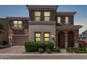 Charming two-story home with a neutral color palette, arched entry, and well-manicured landscaping at 9733 E Axle Ave, Mesa, AZ 85212