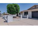Charming home with white brick exterior and a tree in the front yard at 10609 N 32Nd Cir, Phoenix, AZ 85029