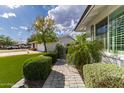Inviting walkway leading to the entrance, surrounded by lush greenery and well-maintained landscaping at 11025 N 45Th Ln, Glendale, AZ 85304