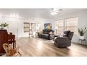 Bright living room with hardwood floors, neutral paint, and abundant natural light at 14205 N 136Th Ln, Surprise, AZ 85379