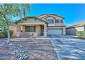 Charming two-story home with a covered porch and a two-car garage and low maintenance landscaping at 16112 W Durango St, Goodyear, AZ 85338