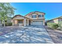 Charming two-story home with a covered porch and a two-car garage and low maintenance landscaping at 16112 W Durango St, Goodyear, AZ 85338
