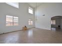 Spacious living room with tile flooring, high ceilings, and clerestory windows at 16112 W Durango St, Goodyear, AZ 85338