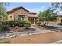 Attractive home featuring a stone facade, well-maintained landscaping, and a welcoming front porch at 21014 W Cora Vista --, Buckeye, AZ 85396