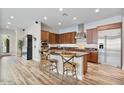 Modern kitchen featuring a large island, stainless steel appliances, granite counters and wood cabinets at 21014 W Cora Vista --, Buckeye, AZ 85396