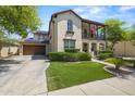 Beautiful two-story home with a well-maintained front lawn, complemented by an attached two-car garage at 21104 W Sage Hill Rd, Buckeye, AZ 85396