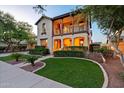 Charming two-story home boasting a welcoming front yard with lush landscaping and a second story balcony at 21104 W Sage Hill Rd, Buckeye, AZ 85396