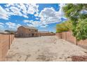 Large backyard with potential for landscaping, features a two-story home with patio at 21972 W Pima St, Buckeye, AZ 85326