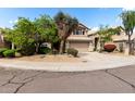 Inviting home featuring mature trees, desert landscaping, a tile roof, and a two-car garage at 236 W Calle Monte Vista Dr, Tempe, AZ 85284