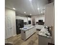 Well-lit kitchen featuring white cabinets, stainless steel appliances, granite countertops, and a functional center island at 2670 S Dragoon Dr, Chandler, AZ 85286