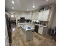 Bright kitchen with granite countertops, white cabinets, stainless steel appliances, and a central island at 2670 S Dragoon Dr, Chandler, AZ 85286