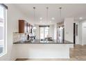Modern kitchen with granite countertops, stainless steel appliances, and open bar seating at 28837 N 127Th Ave, Peoria, AZ 85383