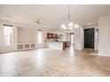 Open floor plan with tile flooring, recessed lighting, and an open kitchen and dining area at 28837 N 127Th Ave, Peoria, AZ 85383