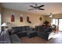 Spacious living room with large sofa, ceiling fan, and tile flooring at 2941 N Oregon St # 12, Chandler, AZ 85225