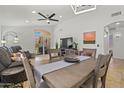 Bright living and dining area with tile floors, ceiling fan, and sliding glass doors opening to the backyard at 3175 E Merrill Ave, Gilbert, AZ 85234