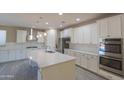 Modern kitchen featuring white cabinets, stainless steel appliances, a kitchen island, and tile backsplash at 3796 E Rakestraw Ln, Gilbert, AZ 85298