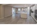 Open-concept kitchen with white cabinets, stainless steel appliances, island, and access to outdoor patio at 3796 E Rakestraw Ln, Gilbert, AZ 85298