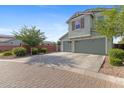 Three-car garage with a spacious driveway and low maintenance landscape at 3881 E Galveston St, Gilbert, AZ 85295