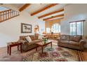 Comfortable living room showcases exposed beams, Saltillo tile, a dining area, and an open floor plan at 39017 N Habitat Cir, Cave Creek, AZ 85331