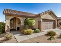 Charming single-story home with a well-manicured front yard and two-car garage, showcasing curb appeal at 40713 N Citrus Canyon Trl, Phoenix, AZ 85086