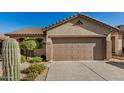 Exterior of home featuring attached two car garage, desert landscaping and tile roof at 40713 N Citrus Canyon Trl, Phoenix, AZ 85086