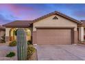 Exterior of home featuring attached two car garage, desert landscaping and tile roof at 40713 N Citrus Canyon Trl, Phoenix, AZ 85086