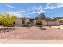 Charming single-story home showcasing desert landscaping and a well-maintained front yard at 4803 W Harmont Dr, Glendale, AZ 85302