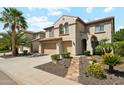 Beautiful exterior elevation featuring a stone pathway and lush landscaping with vibrant yellow flowers at 5136 W Trotter Trl, Phoenix, AZ 85083