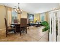 Spacious living and dining area featuring tile floors, ample natural light, and elegant furnishings at 5136 W Trotter Trl, Phoenix, AZ 85083