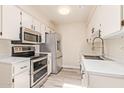A contemporary kitchen features stainless steel appliances, bright lighting, and stylish white countertops at 520 W Hononegh Dr # 2, Phoenix, AZ 85027