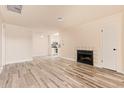 Bright and open living room with fireplace, neutral walls, and wood-look tile floors at 520 W Hononegh Dr # 2, Phoenix, AZ 85027