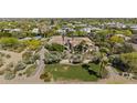 Expansive estate with mature trees, green lawn and circular driveway, a private oasis at 5615 N Invergordon Rd, Paradise Valley, AZ 85253