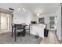 Cozy dining area with chandelier, adjacent to kitchen with updated appliances and natural light at 5704 E Aire Libre Ave # 1246, Scottsdale, AZ 85254