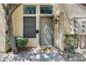 Inviting front entrance with a gray door, decorative window, charming lantern, and stone walkway at 5704 E Aire Libre Ave # 1246, Scottsdale, AZ 85254