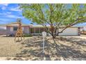 Inviting single-story home featuring desert landscaping, covered porch, and two-car garage at 6749 E Ellis St, Mesa, AZ 85205