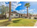 Attractive single-Gathering home featuring a lush lawn and mature desert landscaping at 6907 E Portland St, Scottsdale, AZ 85257