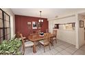 Open dining area with tile floors, dining table, and access to the kitchen at 6945 E Cochise E Rd # 117, Paradise Valley, AZ 85253