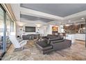 Spacious living room with a modern entertainment center, comfortable seating, and open to kitchen at 7131 E Rancho Vista Dr # 7011, Scottsdale, AZ 85251