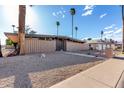 Spacious front yard with desert landscaping and mid-century modern home with a walkway leading to the front entrance at 7604 N 46Th Ave, Glendale, AZ 85301