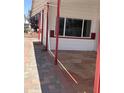 Inviting outdoor space with a red-trimmed awning and unique stained concrete at 7750 E Broadway Rd # 604, Mesa, AZ 85208
