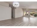 Bright living room with modern lighting, neutral walls, updated flooring, and vaulted ceiling at 10431 E Morning Star Dr, Scottsdale, AZ 85255