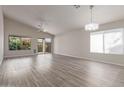 Spacious living room featuring new wood-look flooring, large windows, and sliding glass doors at 10431 E Morning Star Dr, Scottsdale, AZ 85255