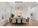 Contemporary dining room featuring stylish lighting, modern decor and plantation shutters at 11143 E Onyx Ct, Scottsdale, AZ 85259