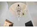 Bright foyer showcases a modern chandelier and a unique, circular ceiling design at 11143 E Onyx Ct, Scottsdale, AZ 85259